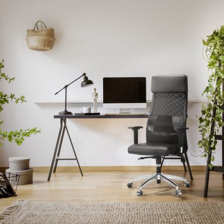 Lamp and computer desktop on black desk in workspace interior wi